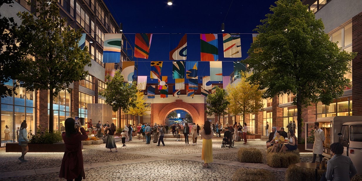 The Arnulfpost courtyard at night with hanging art banners and people gathered for an event.