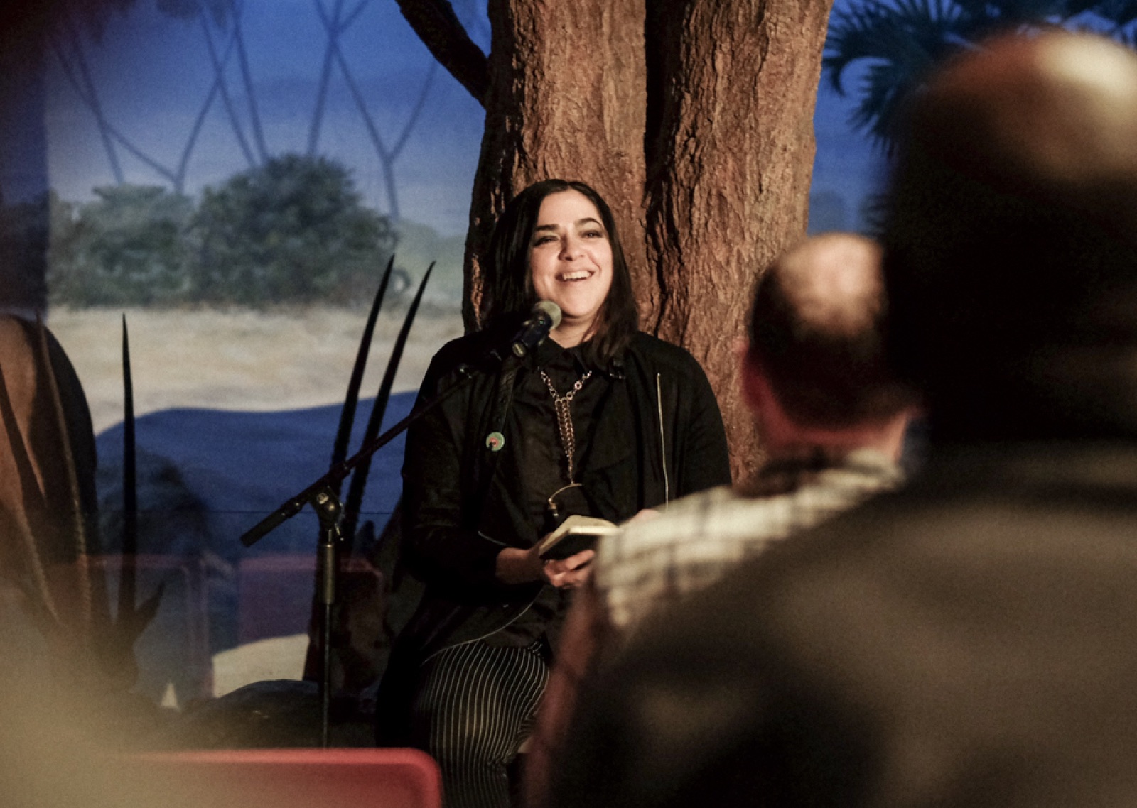 Josette Melchor telling a story on stage at the California Academy of Sciences during Noise Pop.