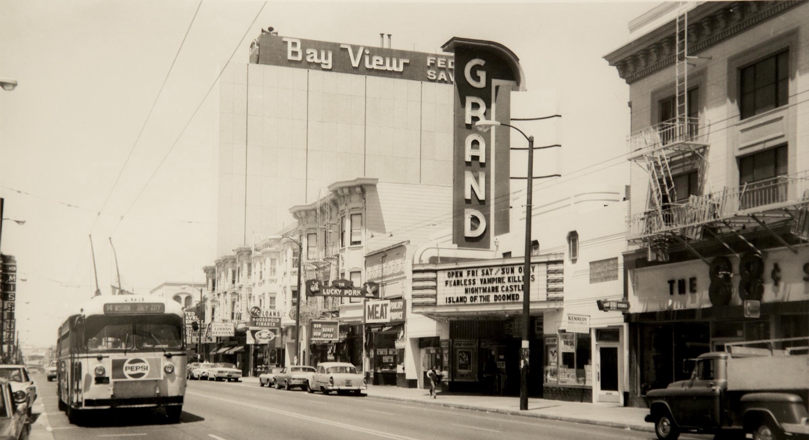 The historic Grand Theater marquee on Mission Street, San Francisco, in a vintage black-and-white photograph.