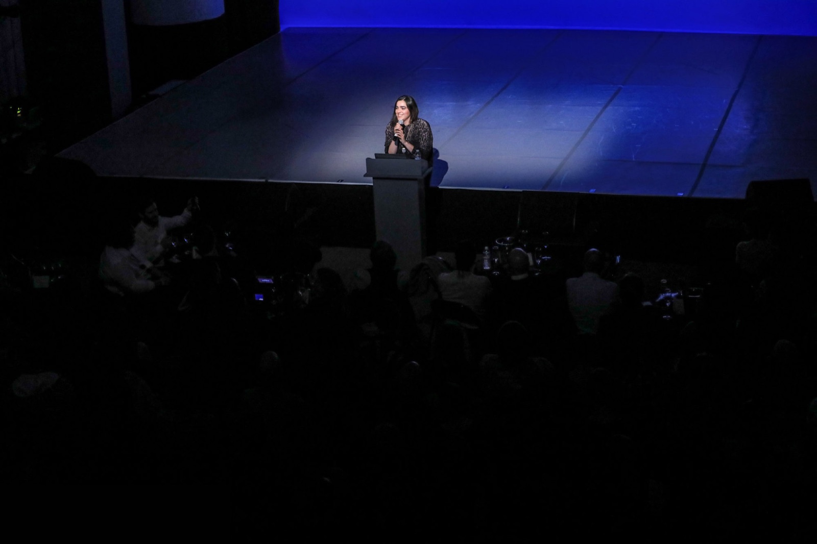 Josette Melchor at the podium introducing Gray Area's tenth-anniversary program.
